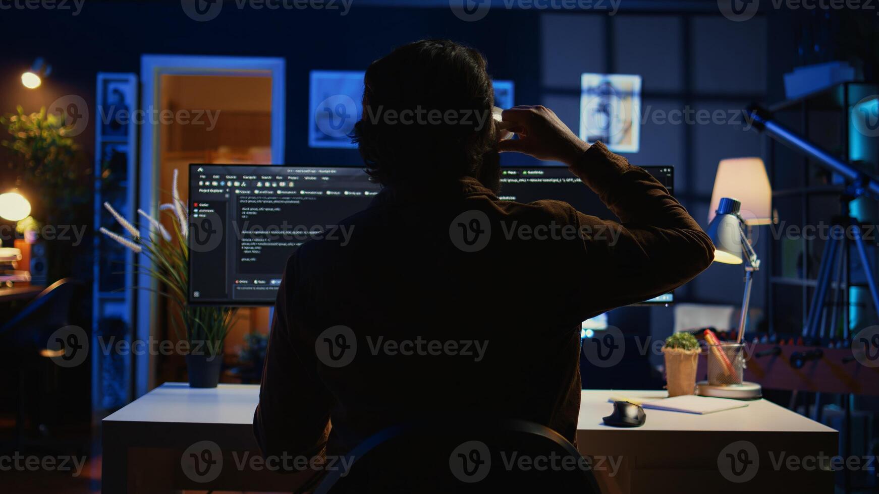 Software engineer writes complex binary code scripts on computer, close up. Teleworking IT specialist in home office using programming to safeguard consumer data, handheld camera shot, camera B photo