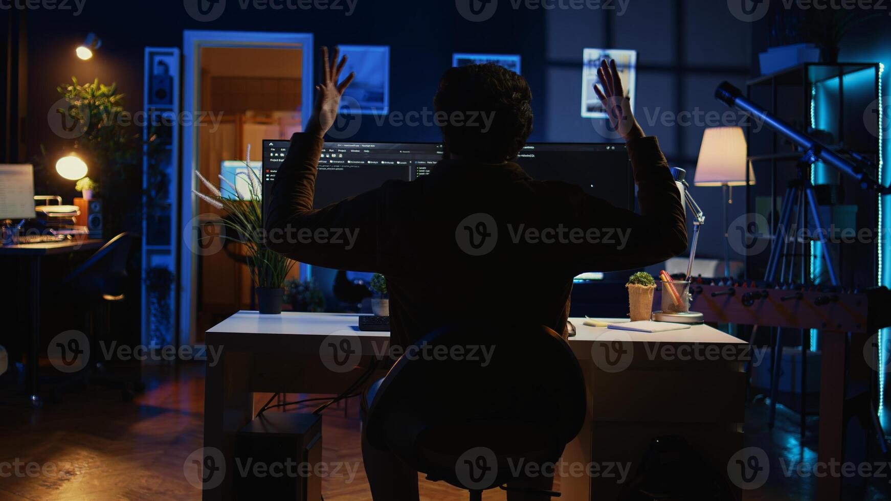 Software technician frustrated while updating complex binary code script on computer at home, receiving errors. Admin confronted with troubling bugs while programming, camera B photo