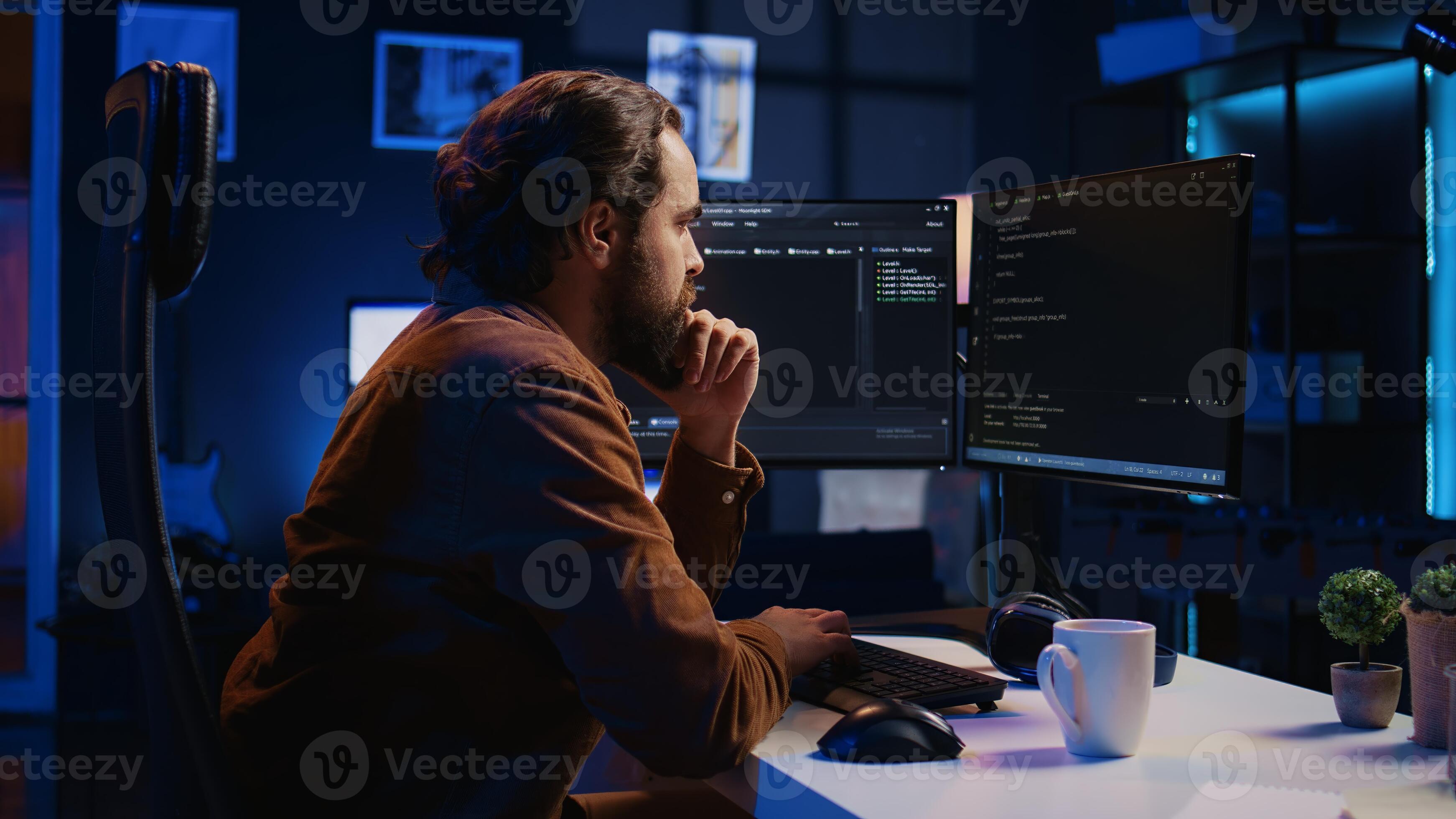 Programmer doing web development during remote job shift in neon lit ...