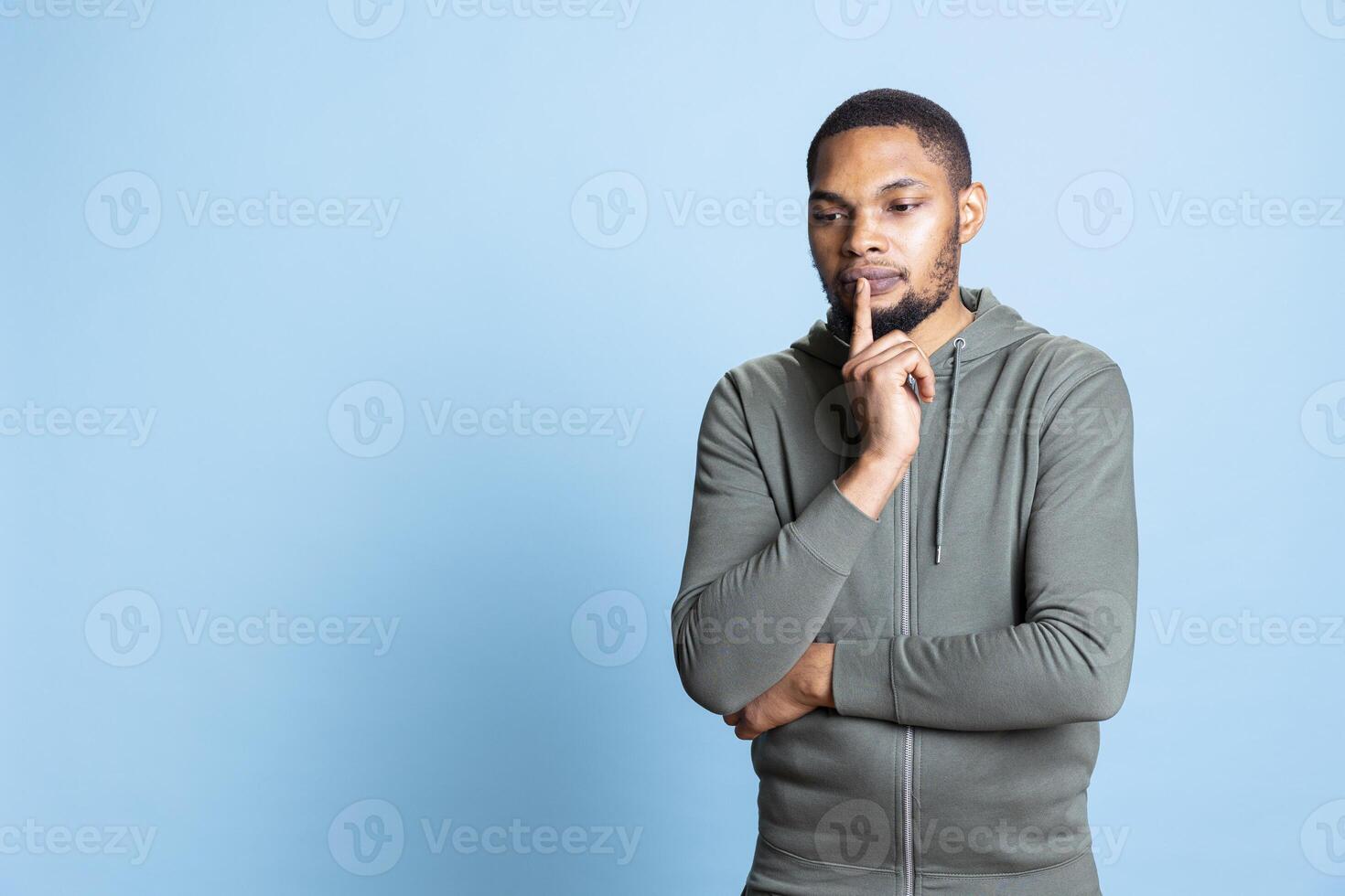 Pensive african american guy acting curious and uncertain about something, thinking about new genius ideas for innovation. Creative doubtful person contemplating for inspiration. photo