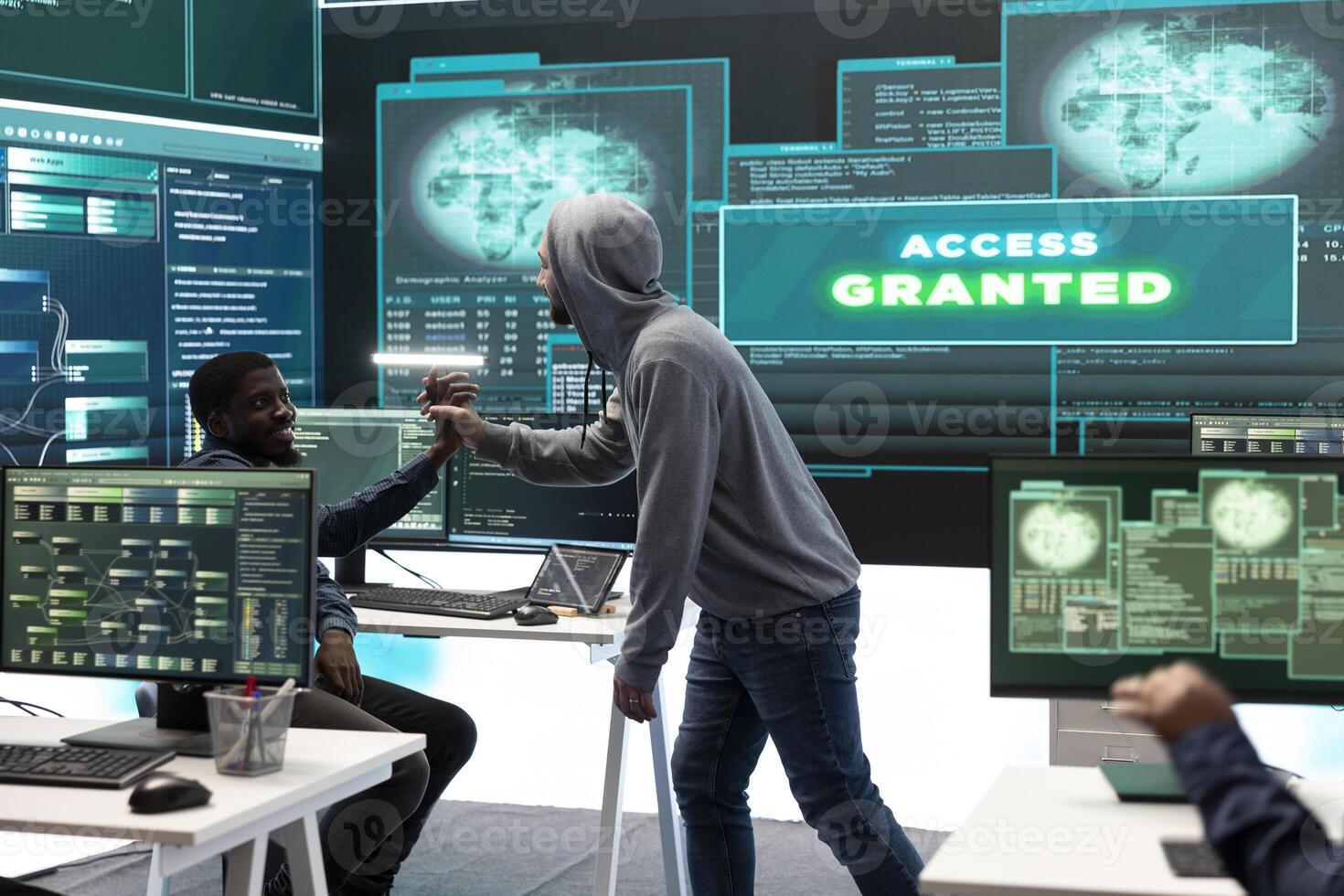 Pleased proud hackers team jumping around after gaining access into rival government database, feeling happy about their success. Professional IT experts hacking network systems. photo