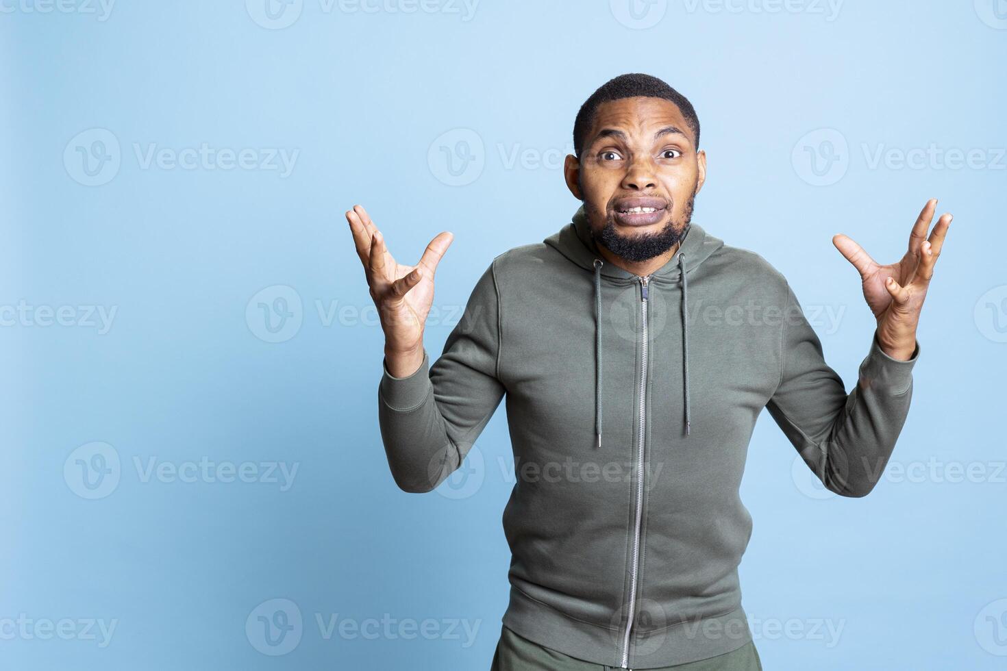 Angry irritated person screaming in front of the camera and showing his frustration, getting aggressive and furious about something. Young adult with mental health problem shows conflict. photo