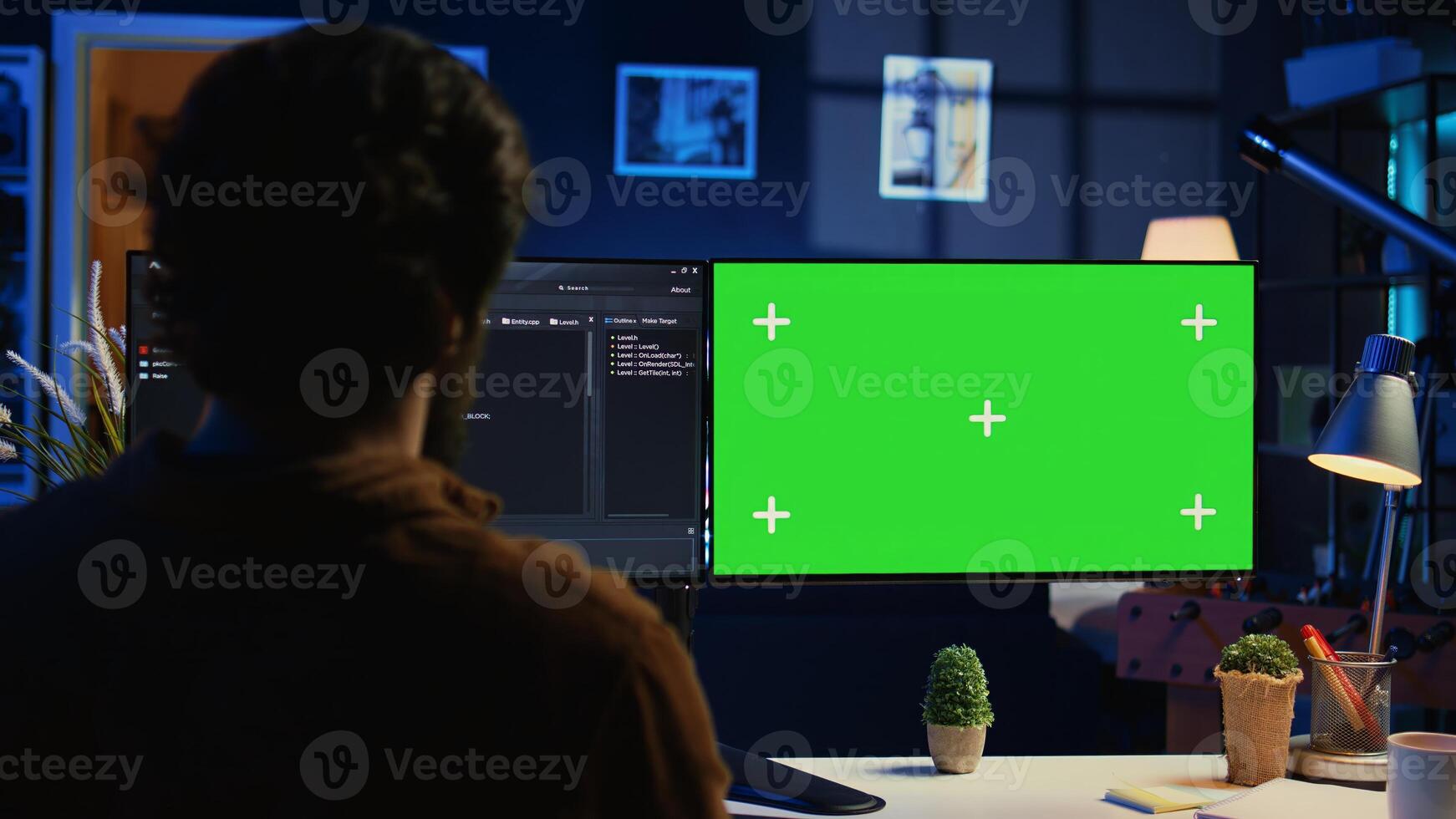 Freelancing man doing IT support job from apartment personal office, coding on isolated screen PC. Software programmer writing lines of code on chroma key computer at home, camera B photo