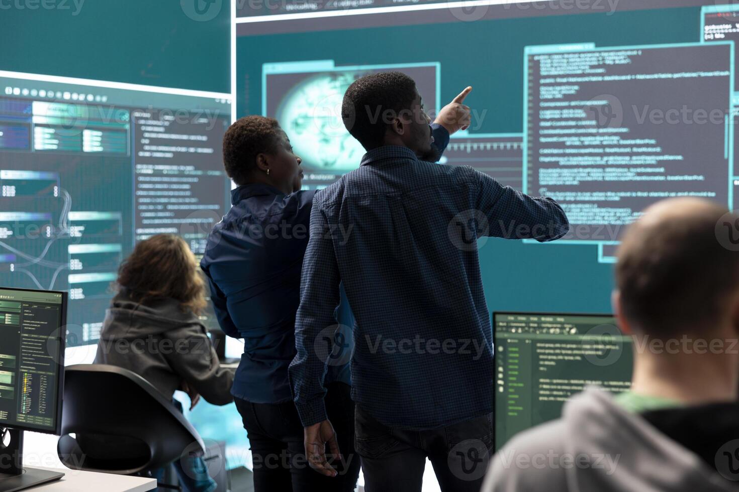 Governmental hacking team launches phishing attack to steal passwords and personal data for cyberwarfare tactics. Group of IT experts working to penetrate a database in monitoring room. photo