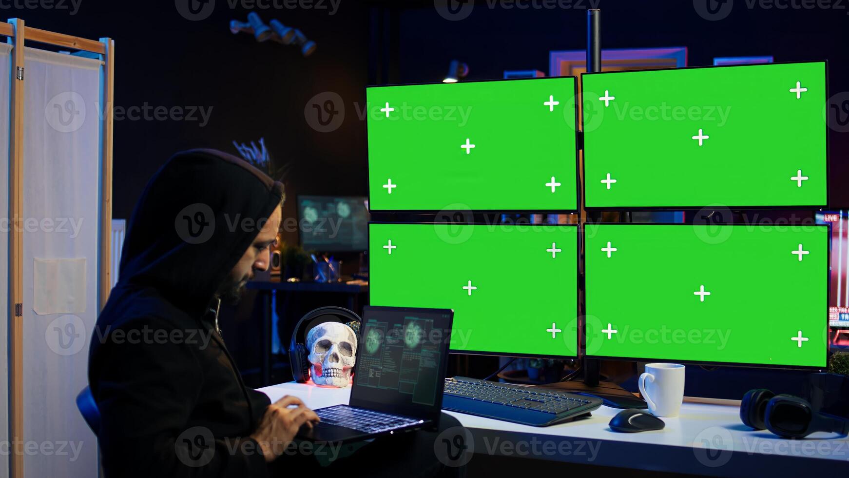 Man writing code on laptop in front of isolated screen PC monitors, trying to get past security systems. Hacker using chroma key computer and notebook to make scripts that can hack devices, camera B photo