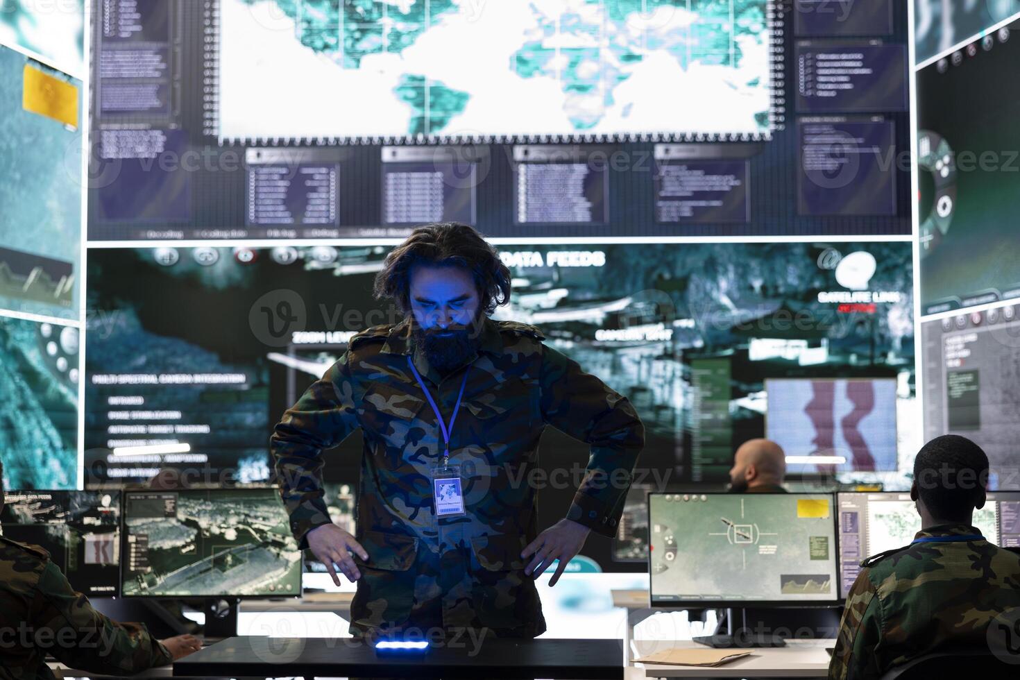 Army conscript examines satellite data on a hologram projection, monitoring registered information from radar surveillance system. Looking at new defense mission details in military base. photo