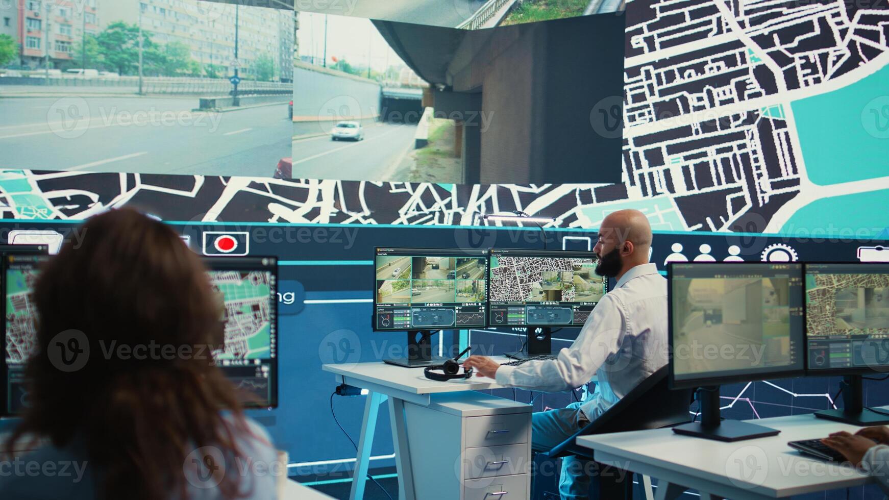 Diverse call center operators monitoring couriers in traffic and update clients on potential order delay due to busy routes. Employees guiding the delivery cars via gps and satellite map. Camera B. photo