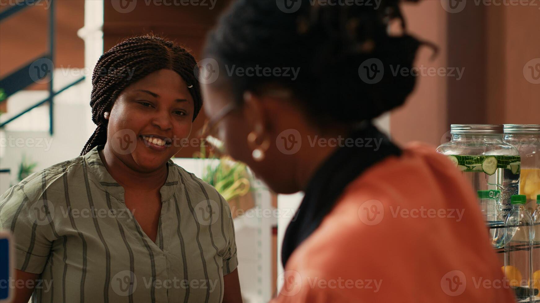 Woman waiting to pay for organic products at checkout, vendor putting all the items on electronic scale to ensure the right price value. Merchant helping client to buy natural eco friendly food. photo