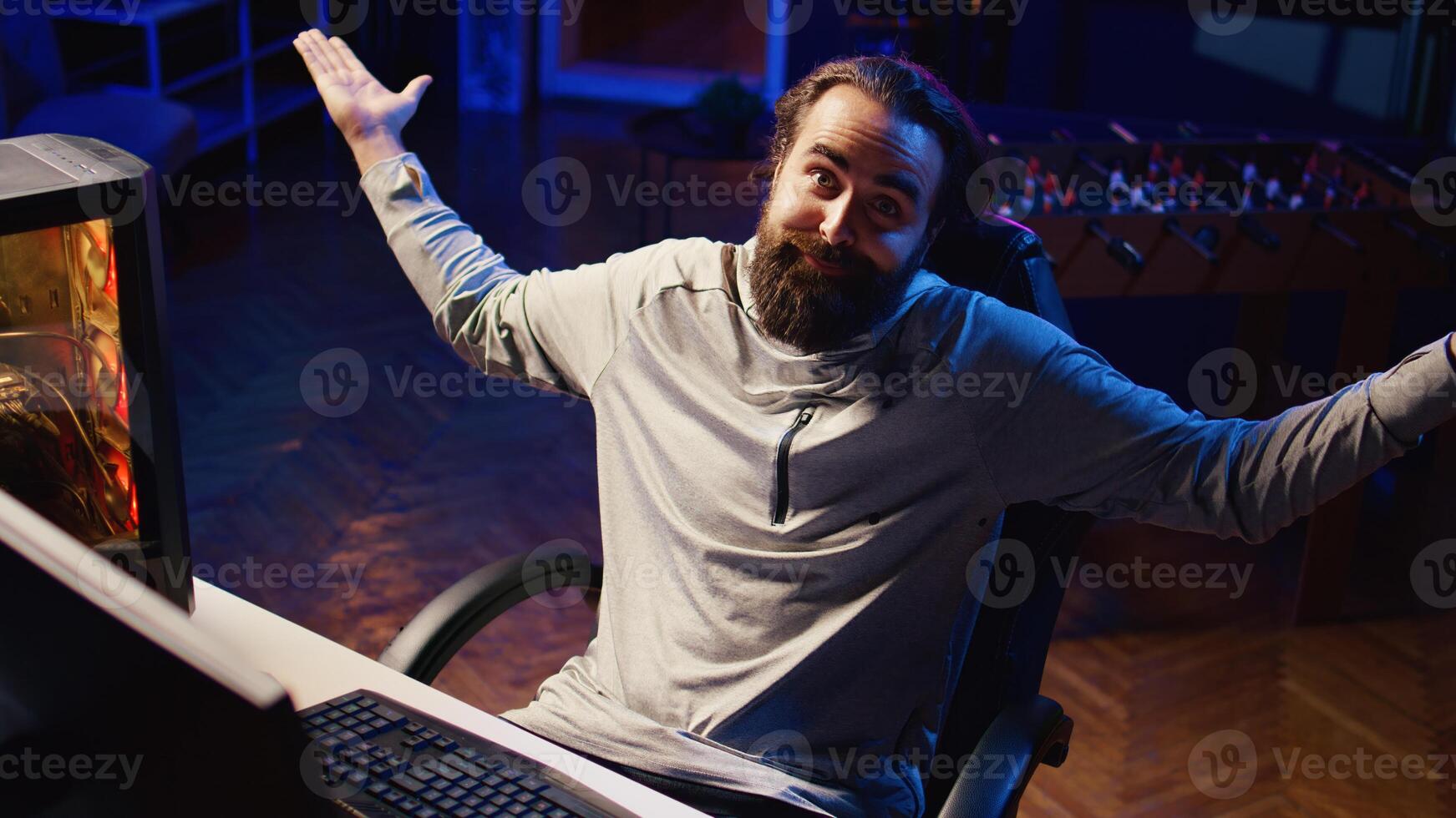 Professional gamer interacting with fans during livestream, disappointed after losing esports match. Man streaming in studio, unhappy with being defeated in online multiplayer videogame photo