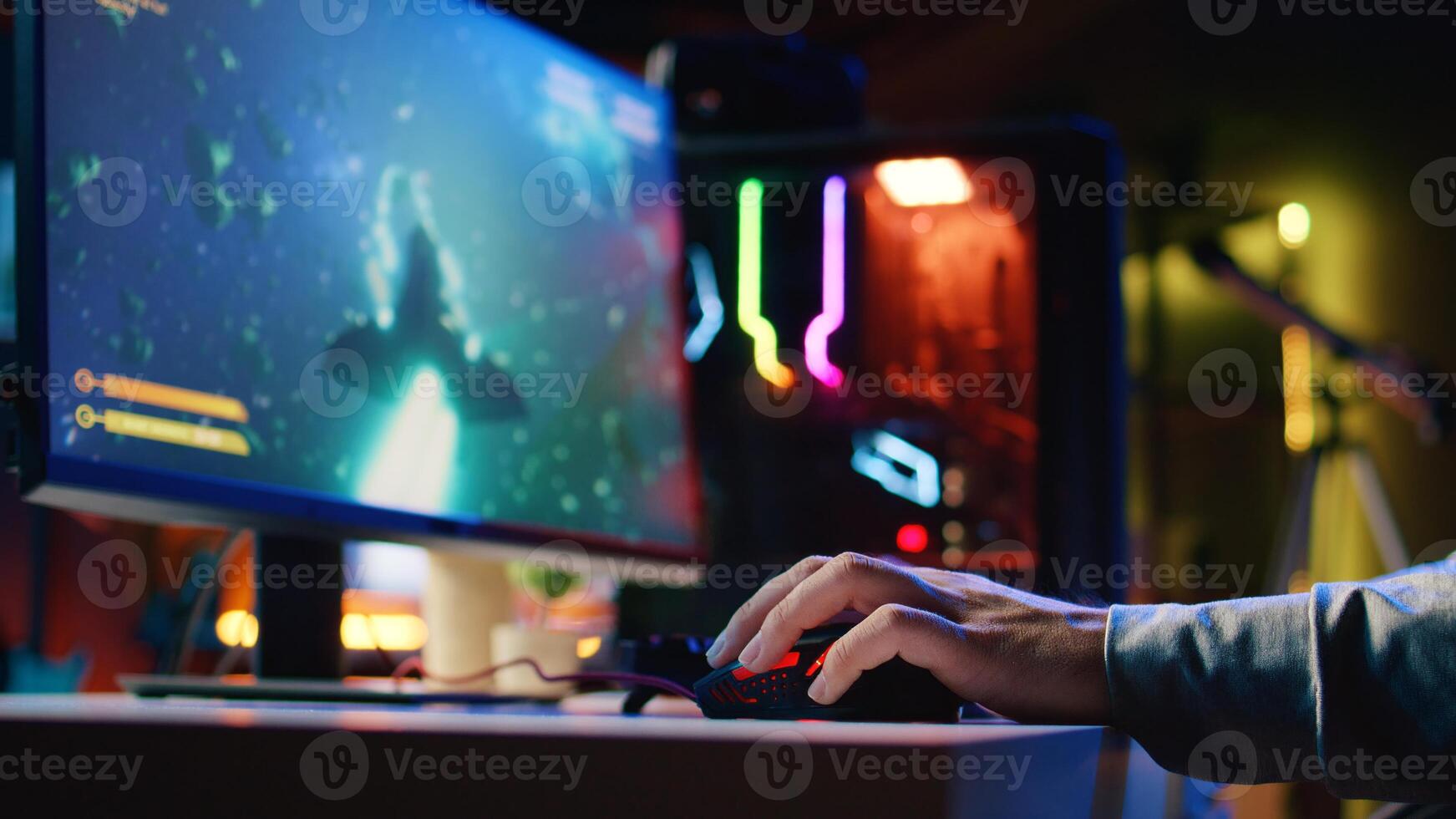 Close up shot of man using gaming rgb lit mouse to play entertaining videogame, flying spaceship through galaxy. Pro gamer using professional computer peripherals to enjoy science fiction game photo