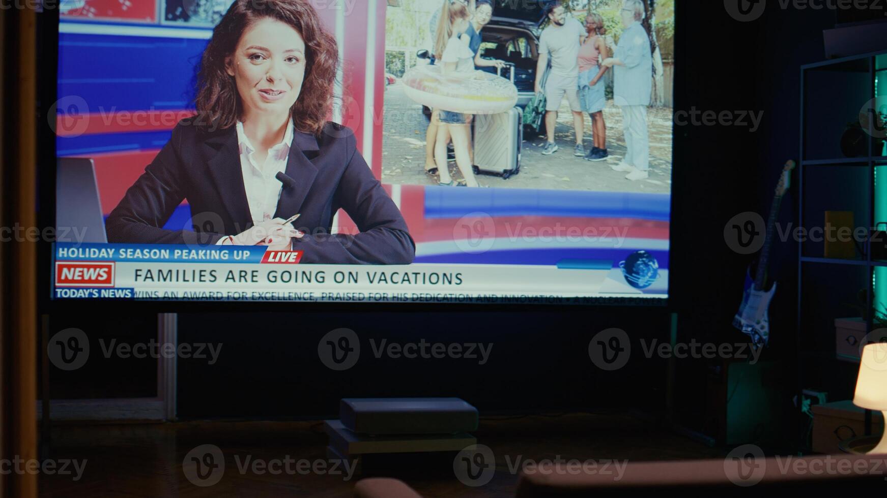 Anchorwoman on large TV screen showing reportage about summer vacations and family trips on VOD travelling channel. Widescreen television set left turned on in empty living room, close up shot photo