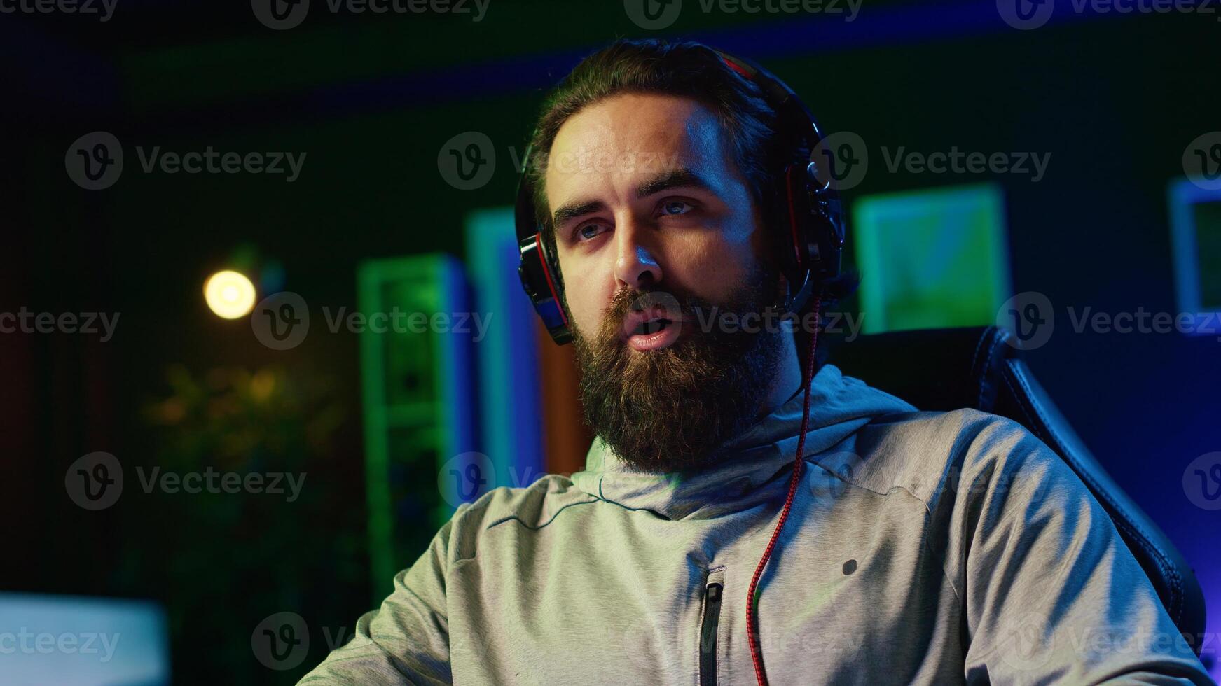 Man filming himself challenging other players in videogame tournaments online while streaming on internet. Zoom in on pro gamer participating in esports contest during livestream with audience photo