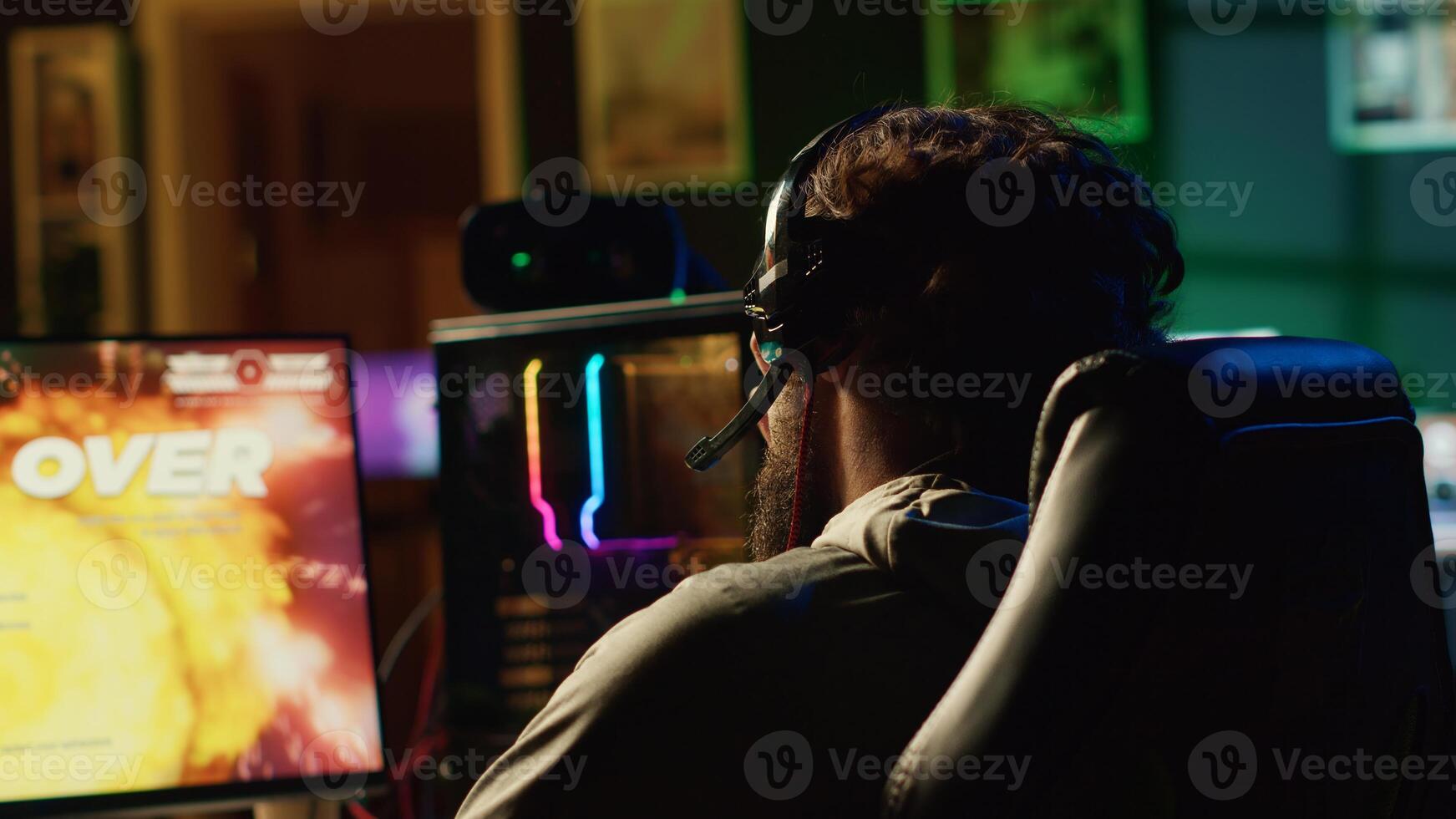 Livid gamer raging in frustration after losing mission while playing spaceship videogame. Mad player furiously yelling after getting flying spacecraft destroyed in game, receiving game over message photo