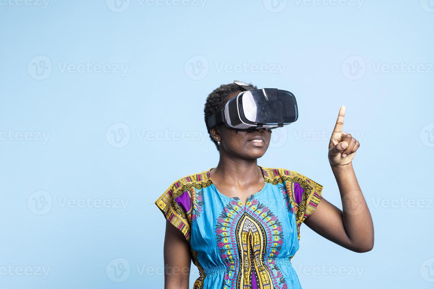 Confident smiling woman wearing virtual reality glasses on camera, having fun using futuristic technology on artificial intelligence interactive headset. Young adult uses vr gadget. photo
