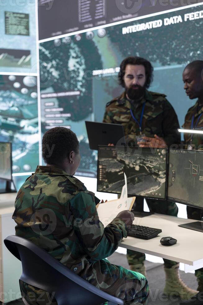 Army personnel providing information for a new national safety mission, diverse team briefing the troopers in a military base of operations. Specialists working in reconnaissance division. photo