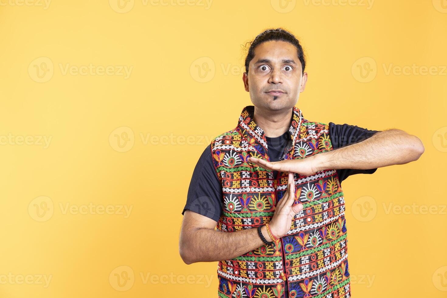 Serious man requesting timeout, doing hand gestures, unable to continue concept. Commanding person doing insistent pause sign gesturing, desiring break, isolated over studio background photo