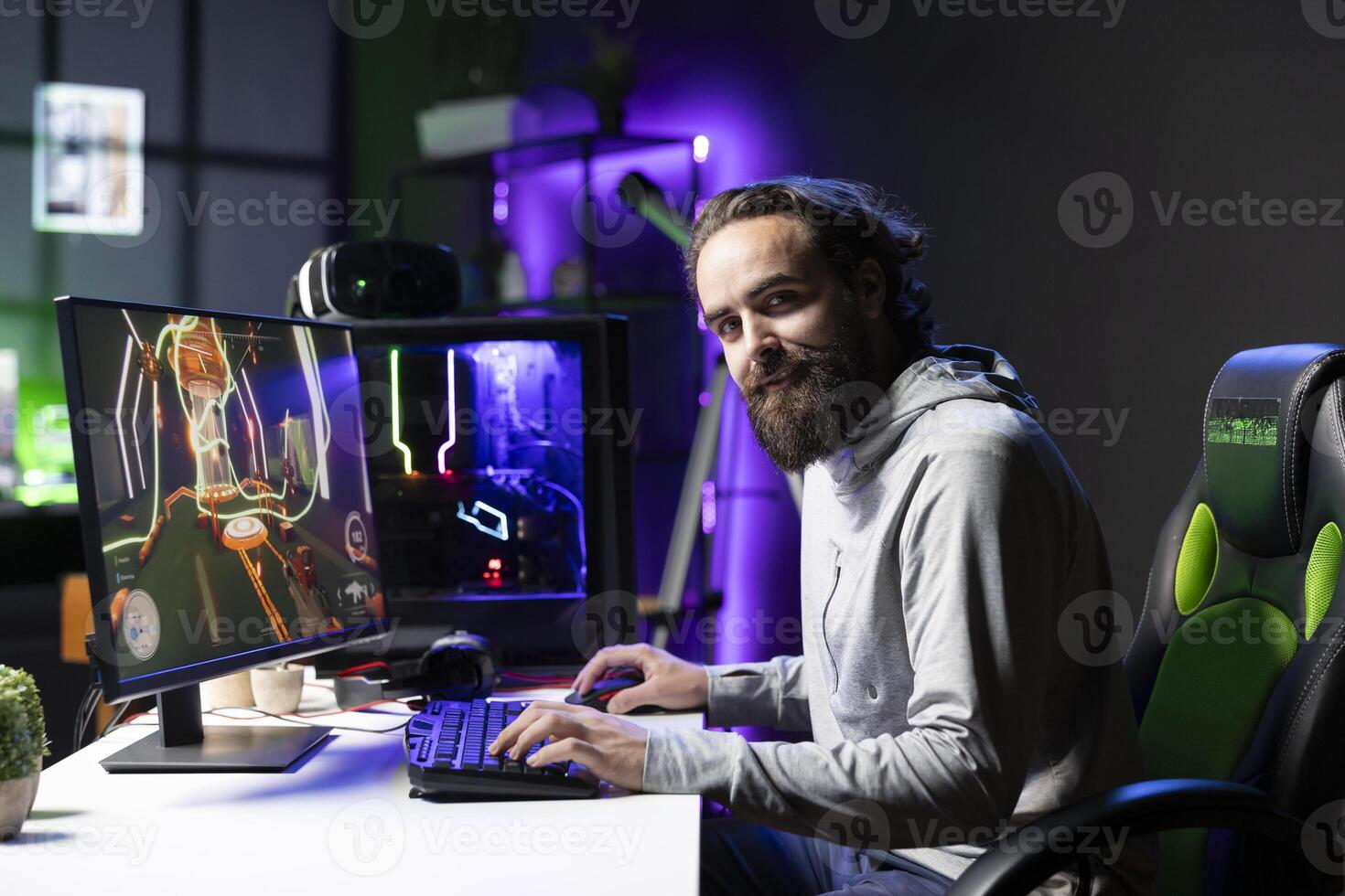 Smiling professional player competing in videogame tournaments online while streaming on internet channels for viewers. Joyful pro gamer participating in esports competition during stream with fans photo