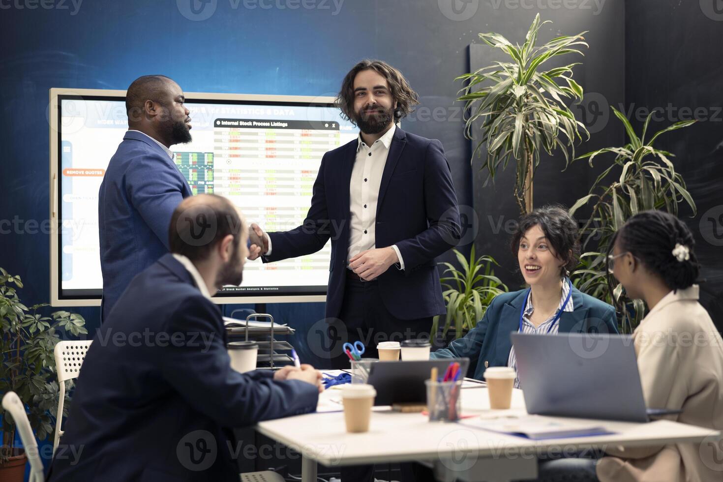 Business associates are shaking hands after initiating new project between their international organizations. Two directors starting collaboration to expand enterprise activity and increase profit. photo