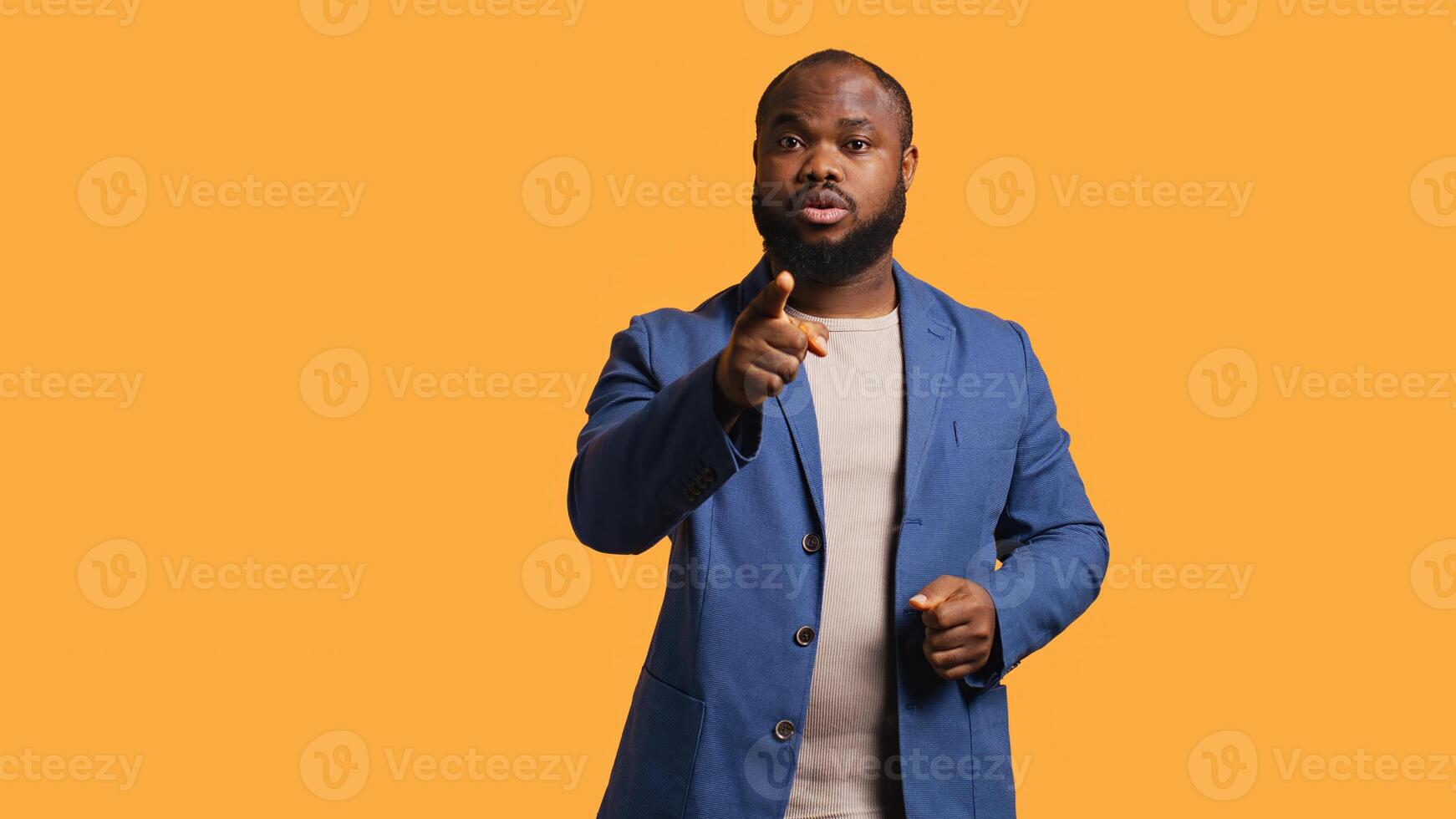 Disappointed african american man admonishing friend over debacle, isolated over studio background. Upset BIPOC person in disagreement with mate, pointing finger and lecturing him, camera B photo