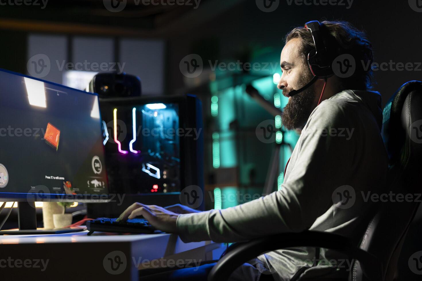 Popular streamer in neon illuminated studio chatting with audience, urging them to pick game for him to play. Pro gamer interacting with viewers watching his livestream, talking about videogames photo