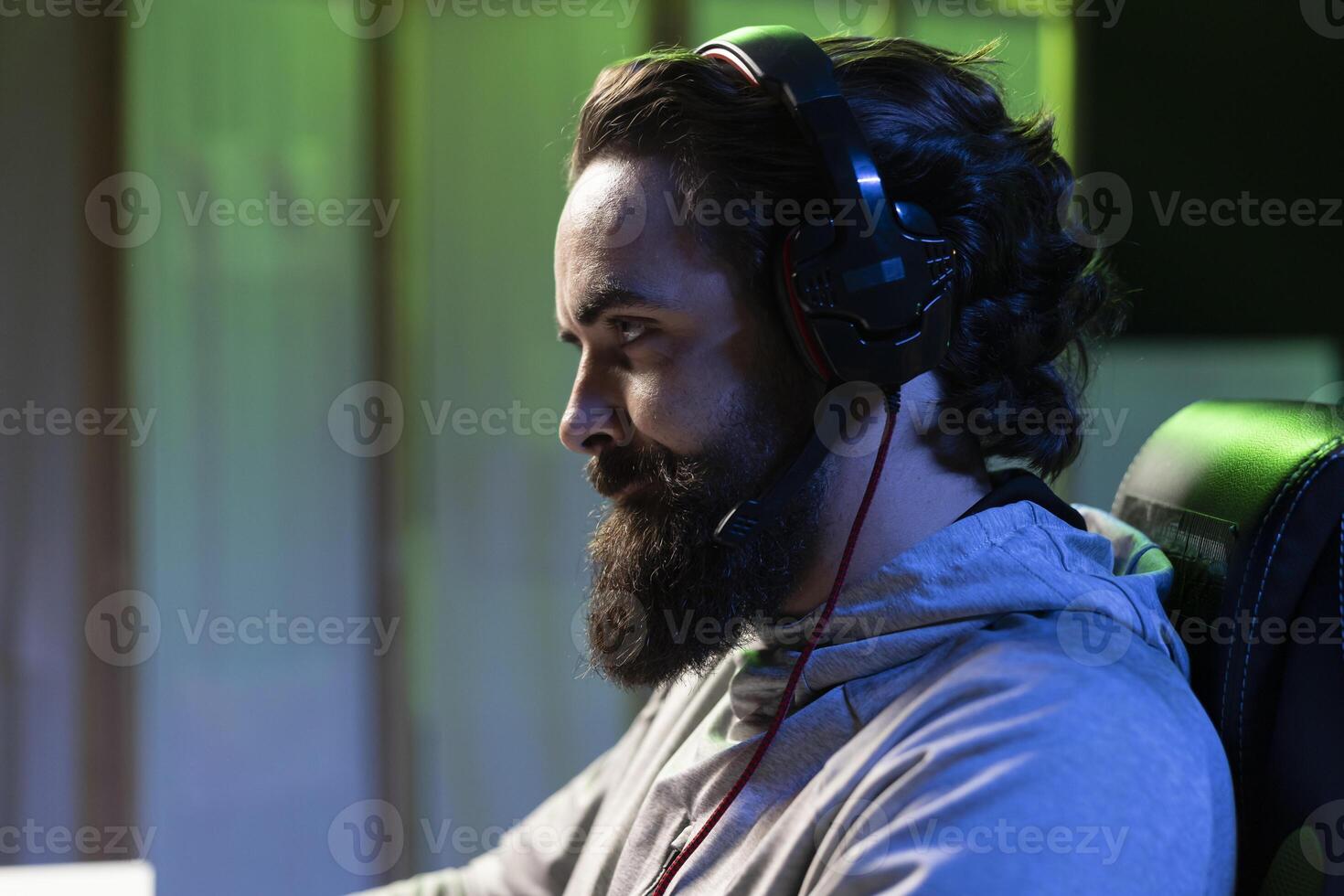 Man discussing with friends online while playing singleplayer videogame, having fun finishing missions together. Close up of gamer chatting with teammates in game using headphones mic photo