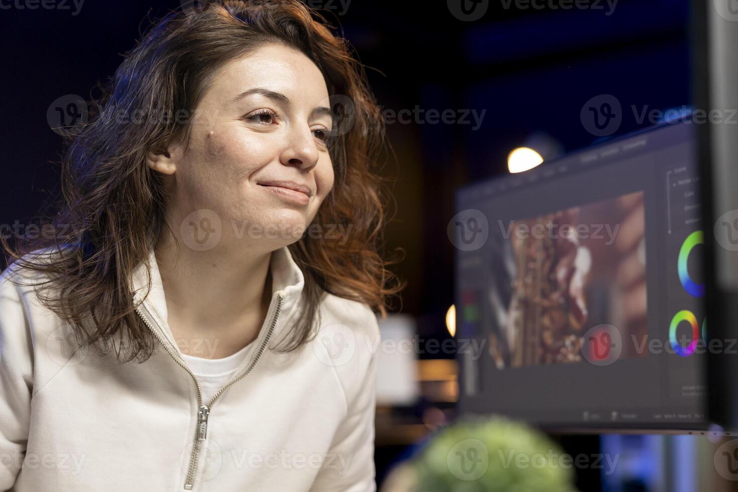 Happy videographer using professional software to create visual effects for projects. Smiling expert using post production techniques to edit raw clips footage in home office photo