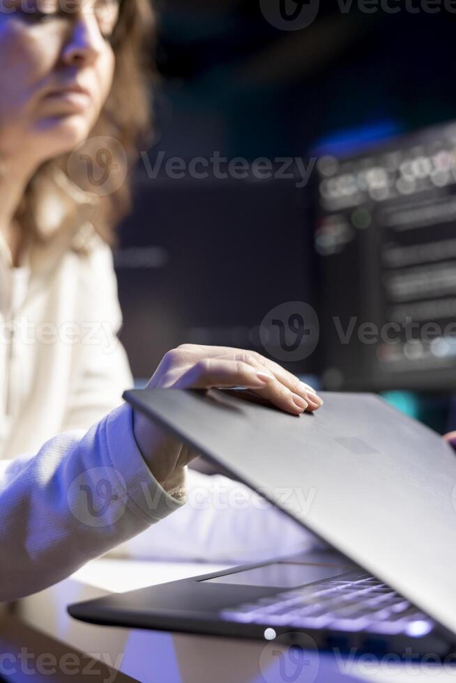 Cybersecurity expert using laptop to look for company security vulnerabilities and injected malware. Programmer installing fortified code on notebook device to prevent cyber attacks photo