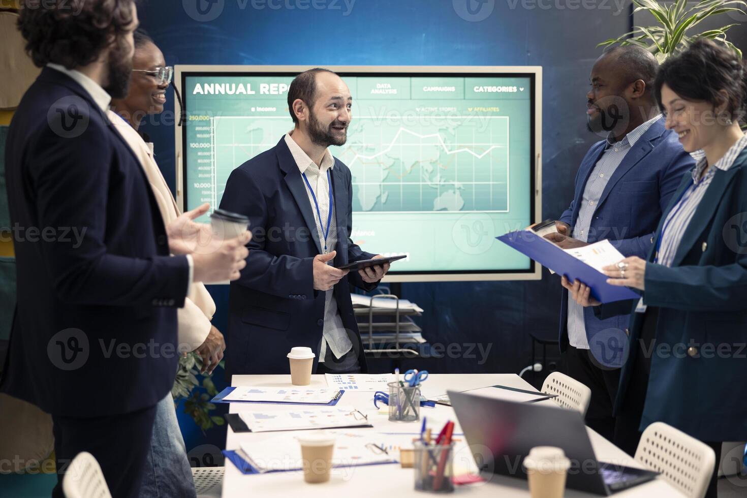 Teammates assembling in a room for meetings to go over their results after examining graphic representations and feedback from stakeholders. Staff and team leader exchange perspectives. photo
