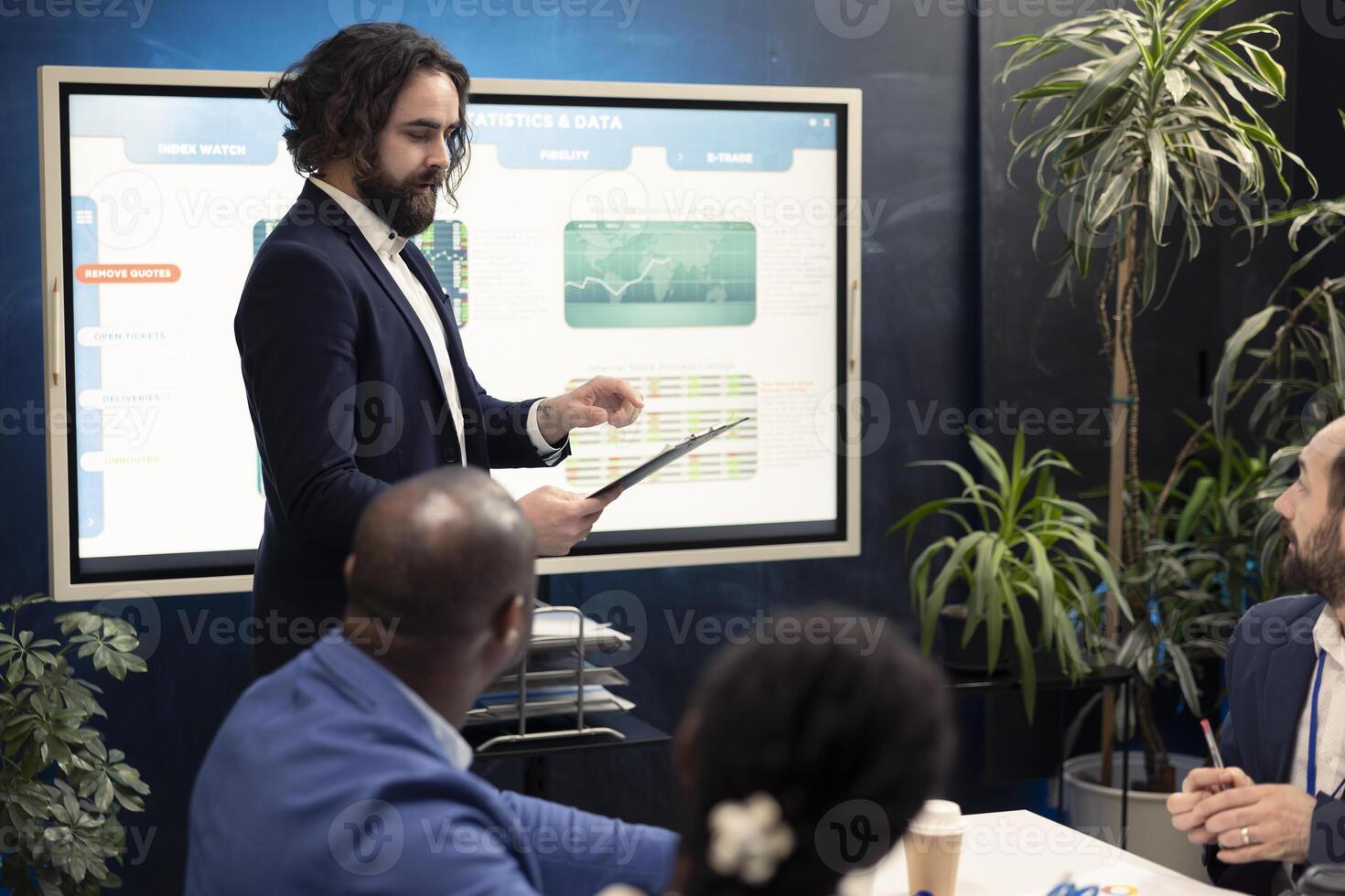 Business peers conducting an informational session to share updates on projects and arrangements, evaluating the latest economic projections on paperwork in order to guarantee progress. photo