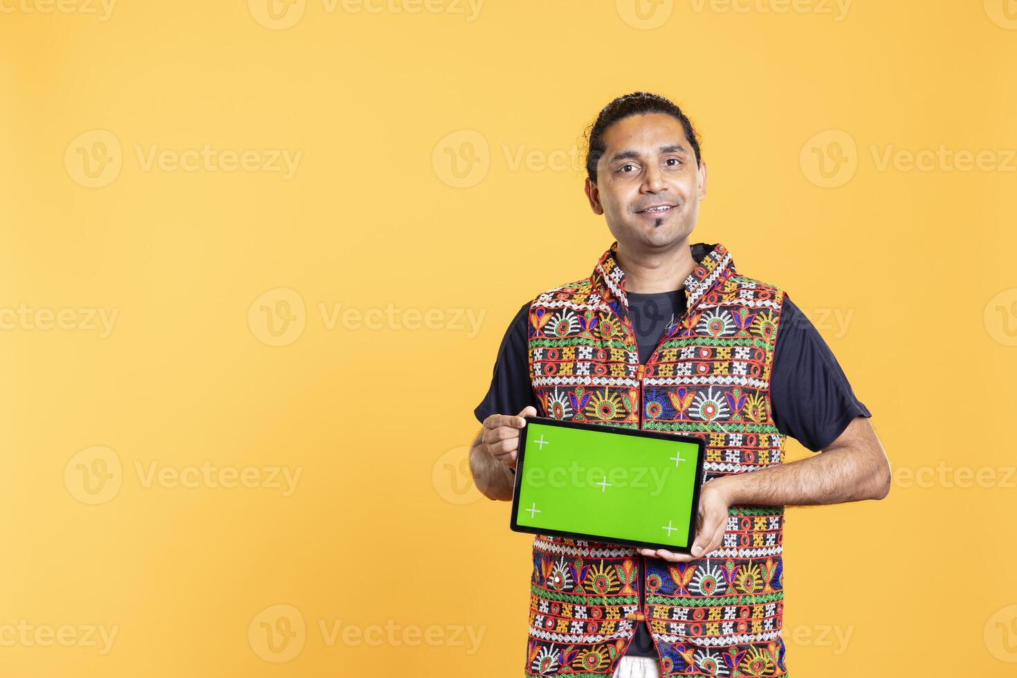 Portrait of joyous man recommending isolated screen tablet, studio backdrop. Happy content creator holding chroma key device used for advertising brands, giving positive feedback photo