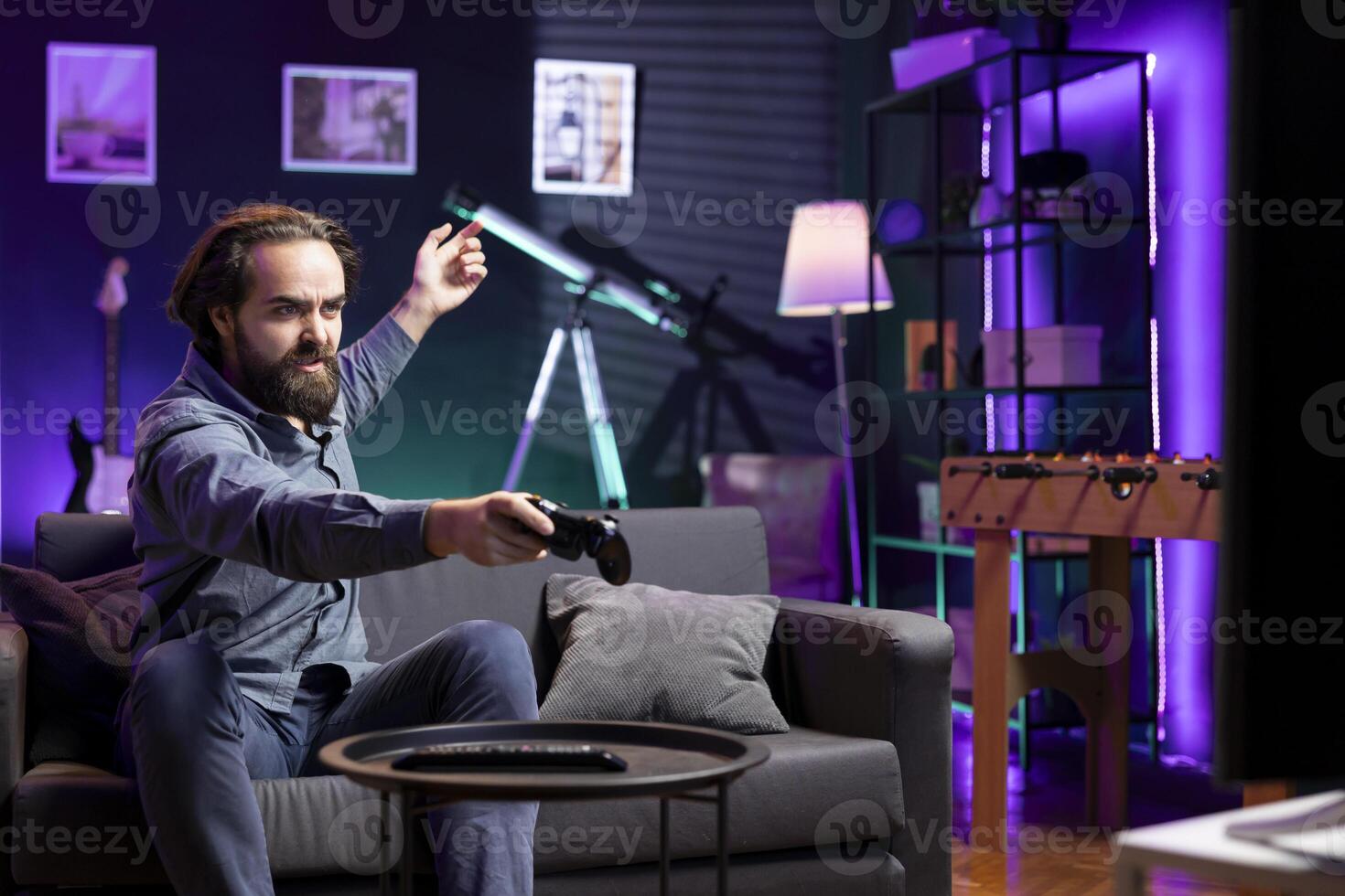 Gamer feeling gutted after losing SF videogame level, screaming at television set in anger. Angry man at home yelling, frustrated after seeing game over screen on smart TV display photo
