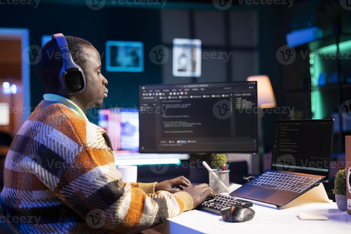 Black software engineer writes complex binary code scripts on computer, cybersecurity. Teleworking IT specialist in home office using programming language to safeguard consumer data. photo