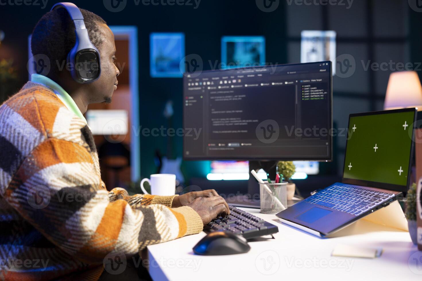 Developer enters binary data on terminal panel next to isolated mockup while he establishes html code. Software engineer works on troubleshooting with programming language, protection of databases. photo