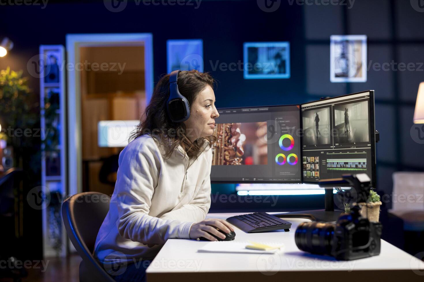 editor adds sound effects to filmed footage, working in post production creative studio. Videographer using headphones to test and improve audio quality, editing clips with professional software photo