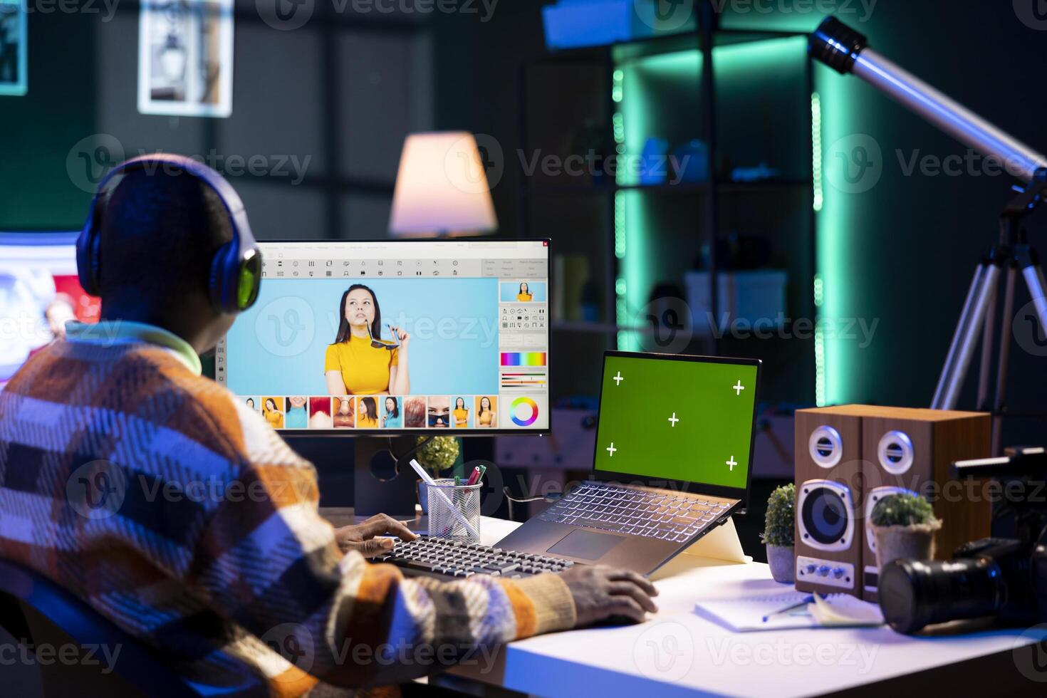 Male graphic artist using essential digital tools next to isolated mockup screen, professional design work showcasing modern setup at home. Designer showing advanced photo editing skills.
