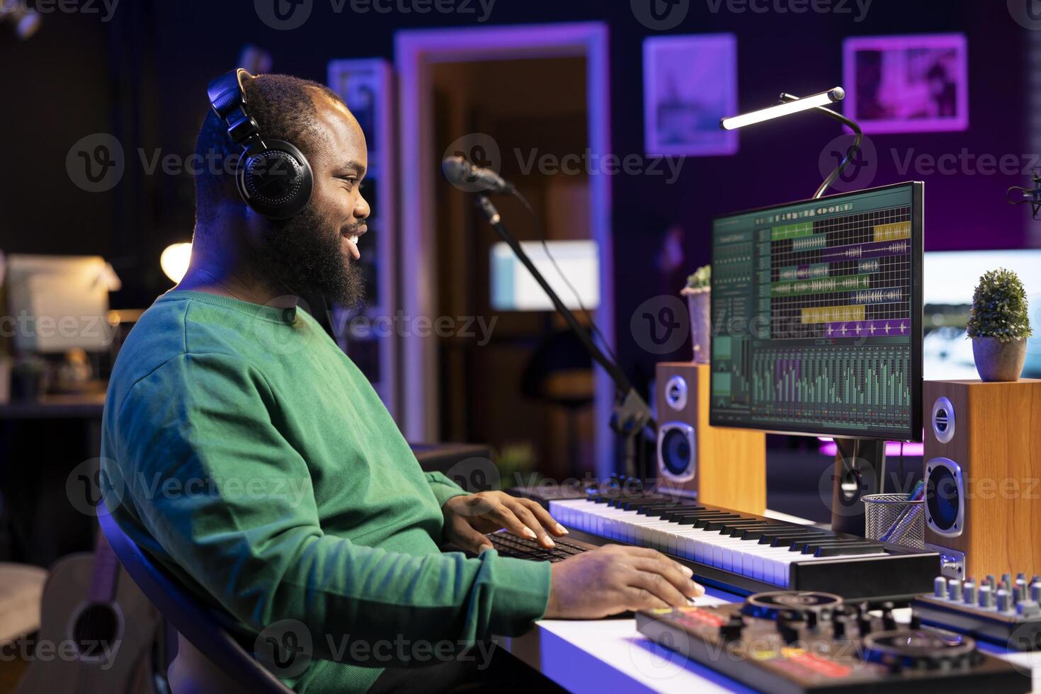 Music producer editing old audio recordings on professional software, operating on mixing console and stereo gear. Sound engineer producing new songs with acoustical tunes in home studio. photo