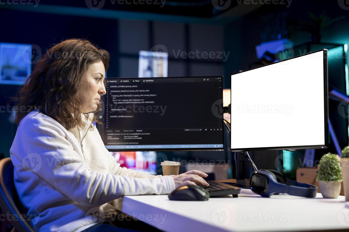 Programmer doing software debugging on isolated screen PC at home, checking broken lines of code displayed on monitors. Woman in living room fixing coding problems on mockup computer photo