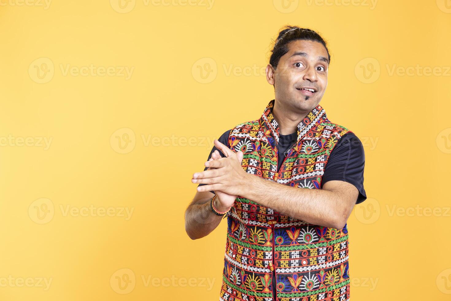 Portrait of jolly spectator smiling clapping hands, praising entertainers, studio background. Upbeat person reacting to spectacle by applauding, doing standing ovation, satisfied by show photo