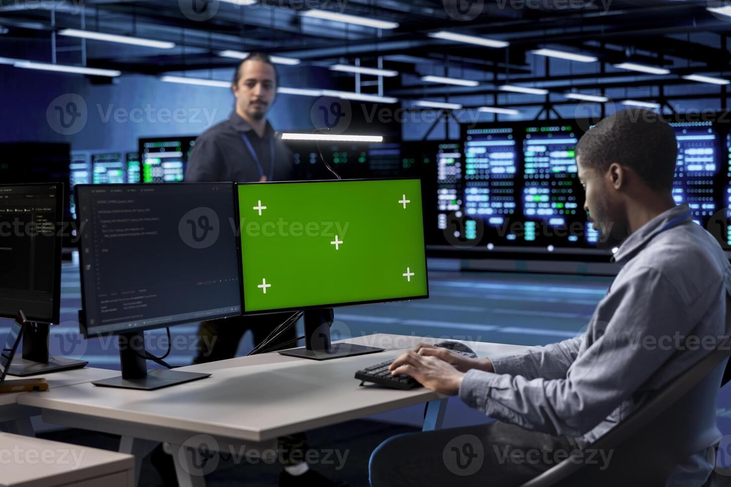 Developer in server room checking recovery plan and monitoring energy consumption using isolated screen PC. Employee in data center workplace doing disk checks using chroma key computer photo