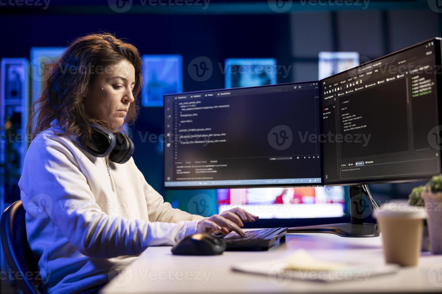 Freelancing professional working from home developing software in Java programming language using PC. Software technician in apartment writing lines of code on computer using keyboard photo