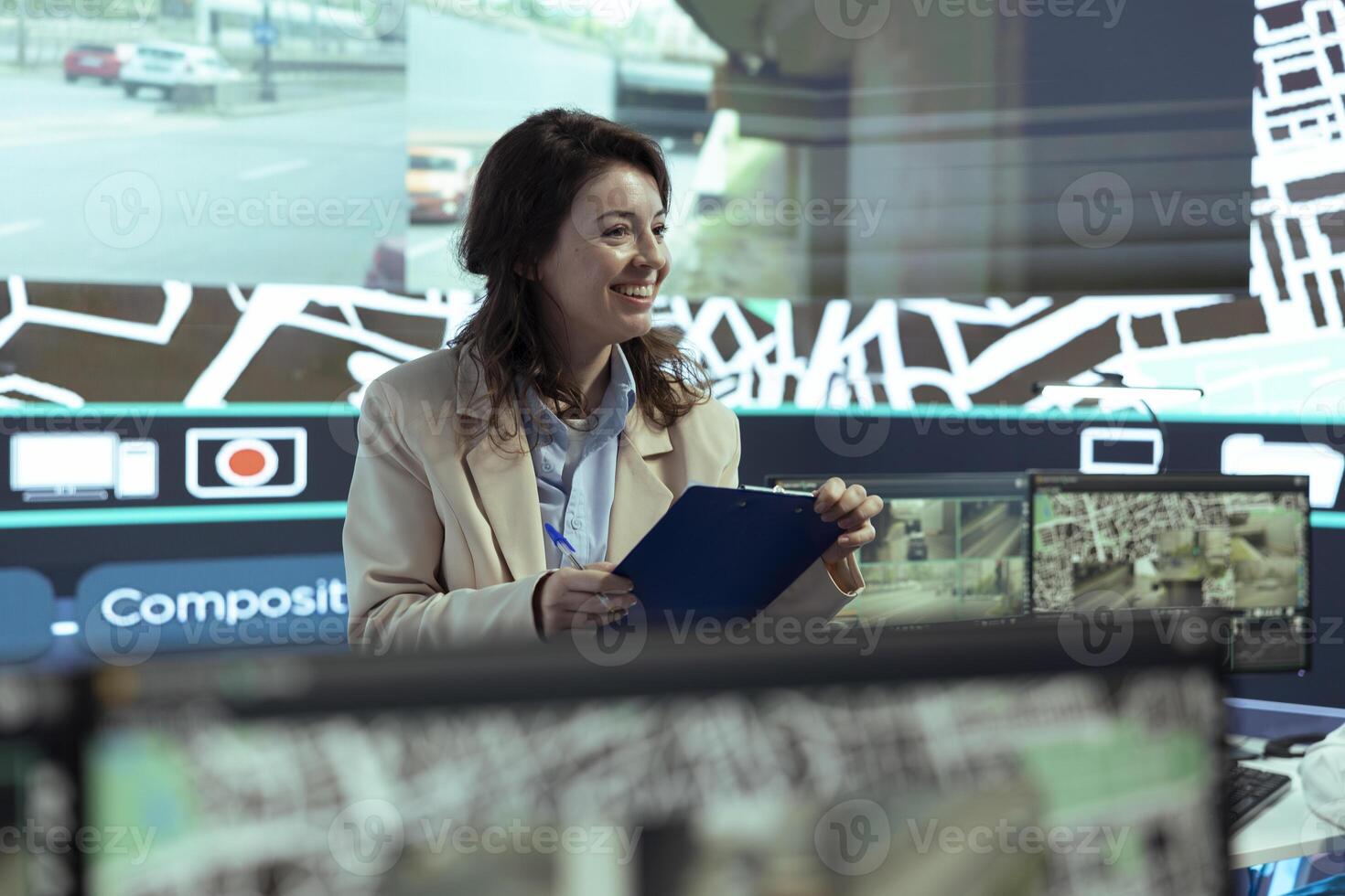 Manager gives order tracking details to her employees in control center, working together to guide delivery trucks on less busy directions. Using surveillance footage and gps locating. photo