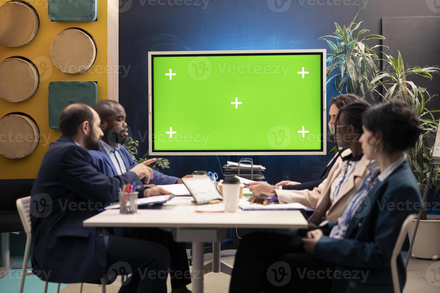 Marketing experts meeting in a boardroom with isolated TV layout, working to improve the enterprise image and social media presence. Business specialists conducting multiple analysis. photo