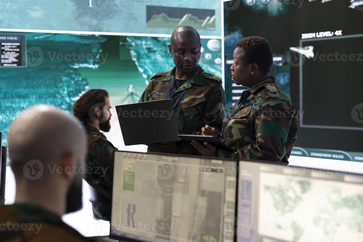 Female infantry unit soldier and new recruit discuss about mission details, gathering intelligence via radar surveillance on a big screen. National guard protection with a world map. photo
