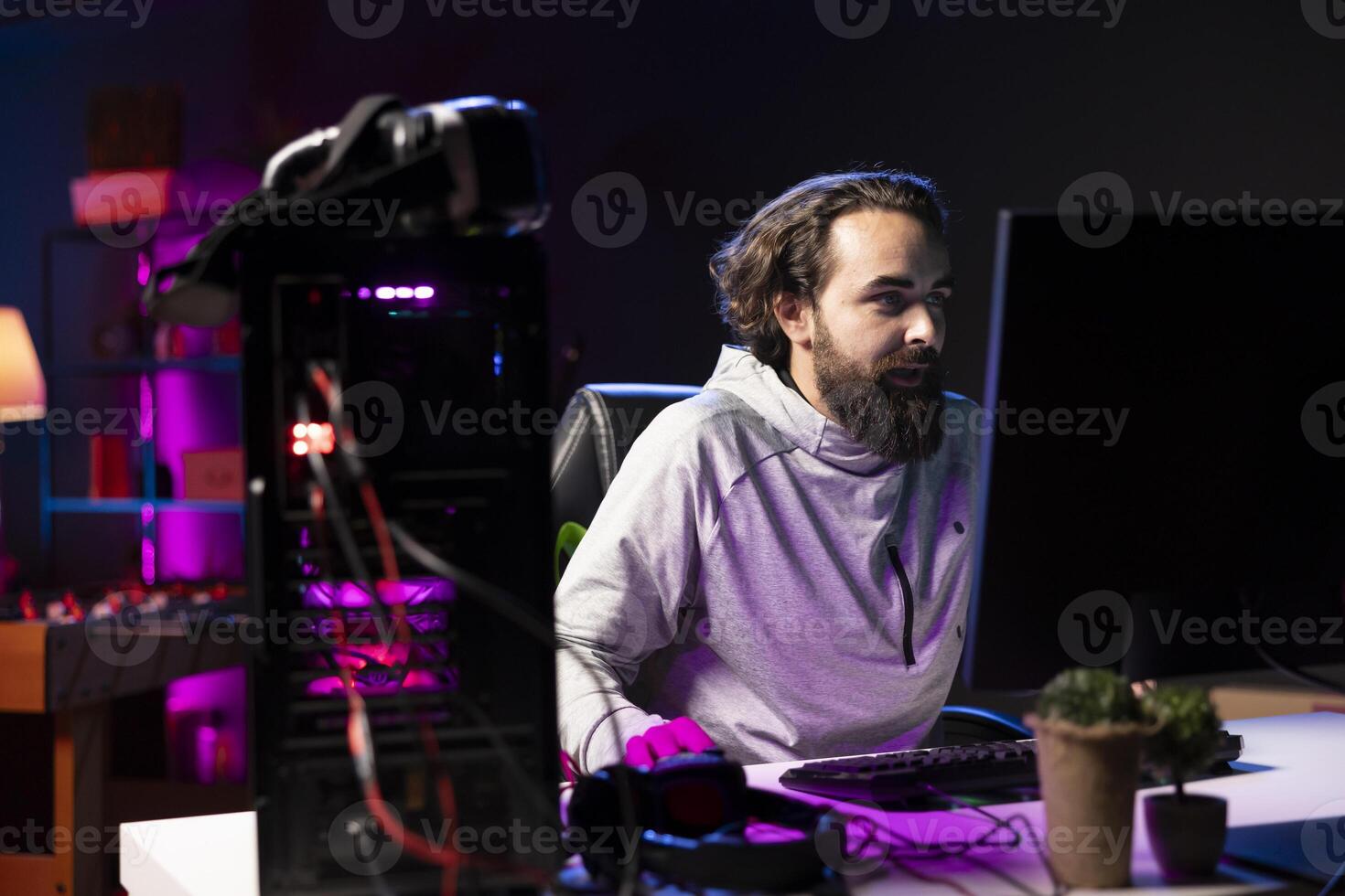 Man at home playing singleplayer videogame shooting enemies to finish level. Pro gamer destroying opponent team members in science fiction game using gaming mouse, having fun photo