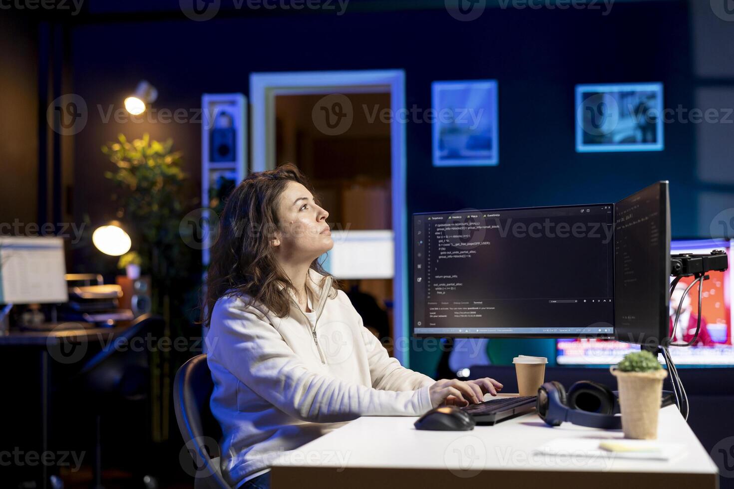System administrator looking at AR visualization to fix vulnerabilities in software. Cybersecurity specialist using computer to patch security exposures using augmented reality tech photo