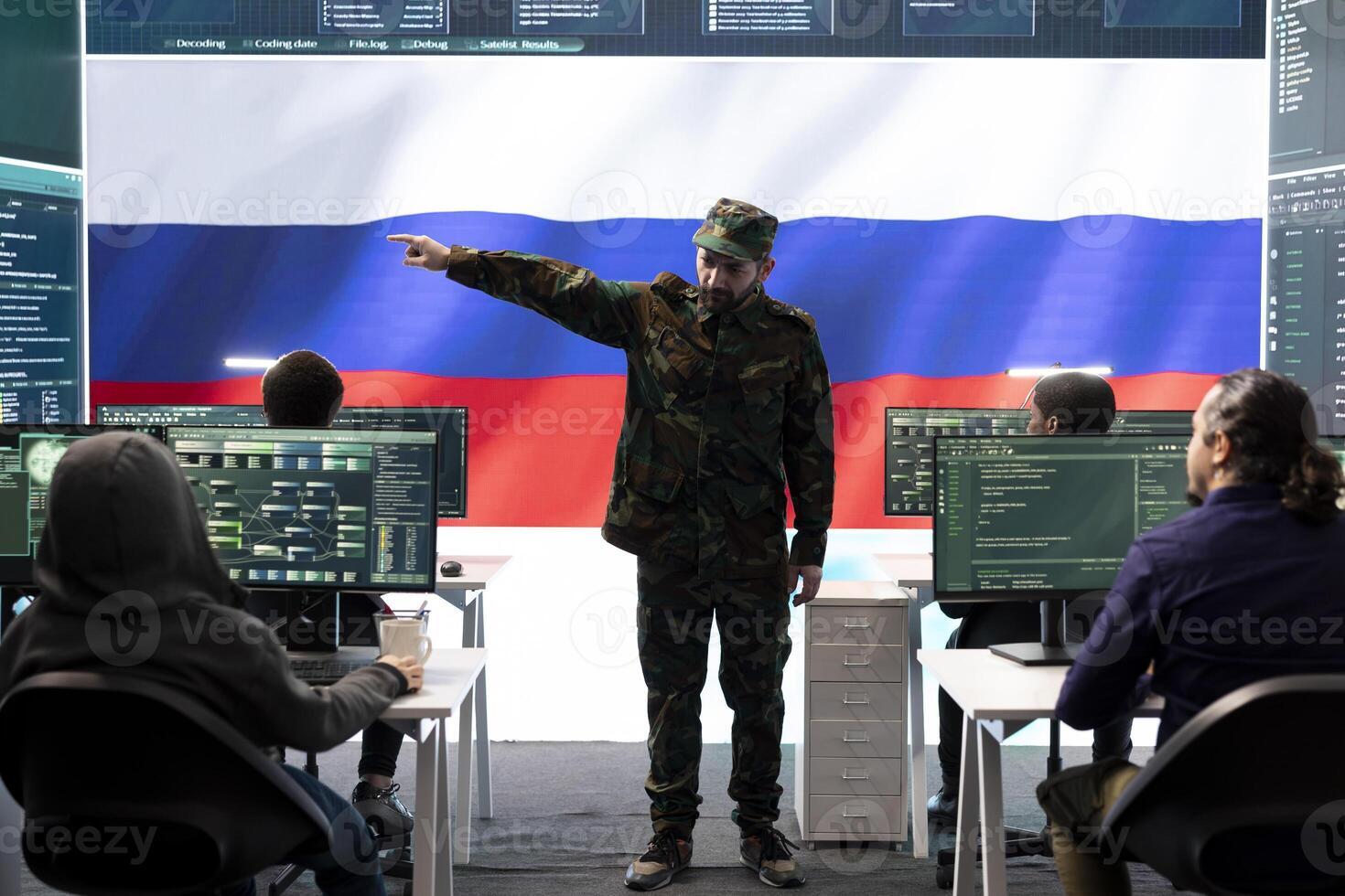 Russian army officer supervising cyber attacks on state networks, spreading misinformation and fake news around Europe during hybrid war. Military personnel works on scams and hacking. photo
