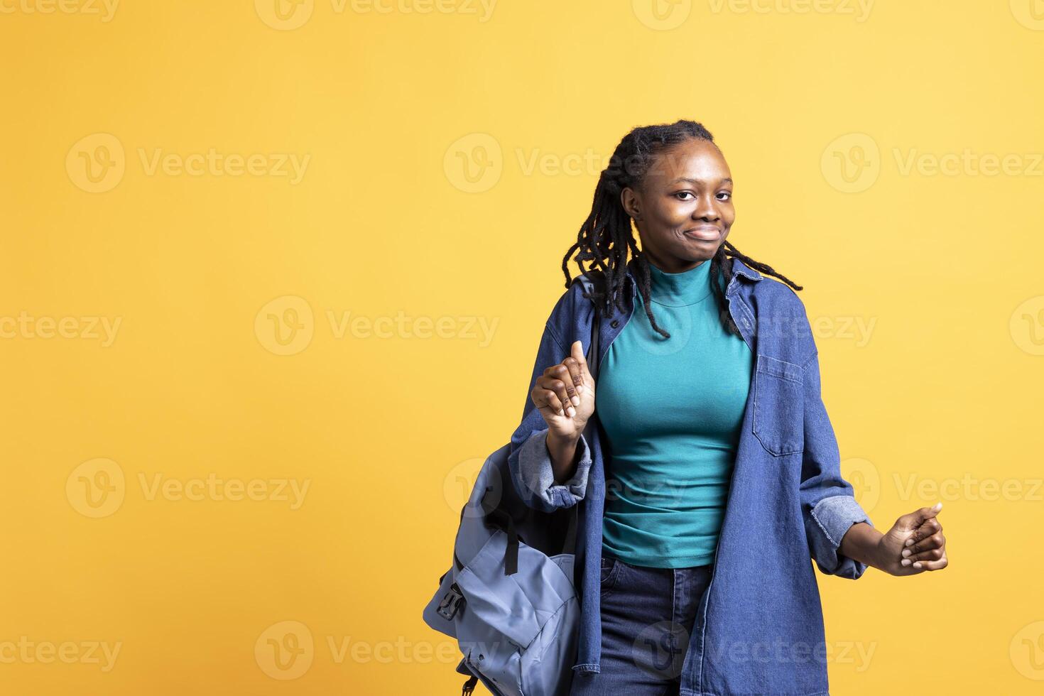 Happy african american person having fun, dancing on rhythm, enjoying leisure time. Cheerful BIPOC woman entertaining herself doing funky movements on music, studio background photo