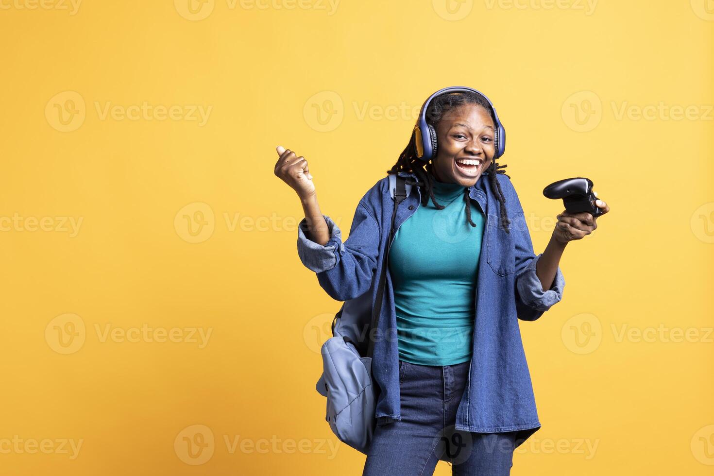 Overjoyed person playing intense gaming console game, having fun, isolated over studio background. Joyous woman pleased after being victorious in videogame, defeating all enemies using gamepad photo
