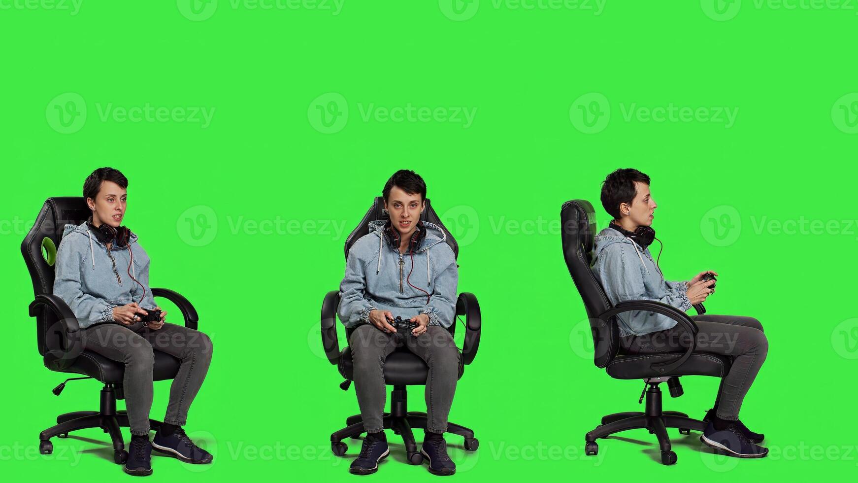 Young woman celebrating games win against greenscreen backdrop, sitting on an office chair and playing online e sport tournament. Gamer feeling happy about winning worldwide game. Camera A. photo
