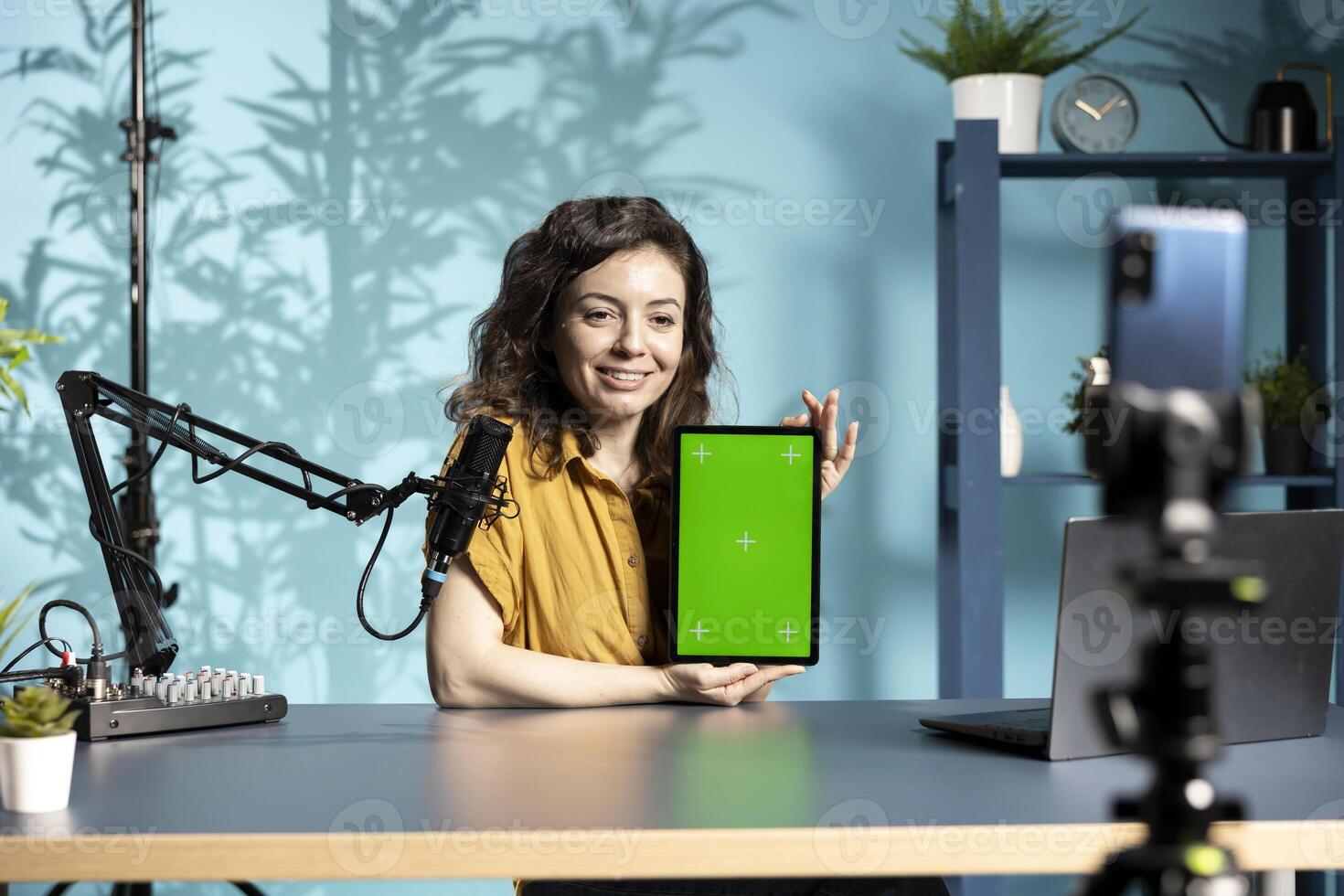 Smiling content creator reviewing mockup tablet received from sponsor, doing influencer marketing. Happy media star promoting isolated screen digital device during sponsorship advertising photo